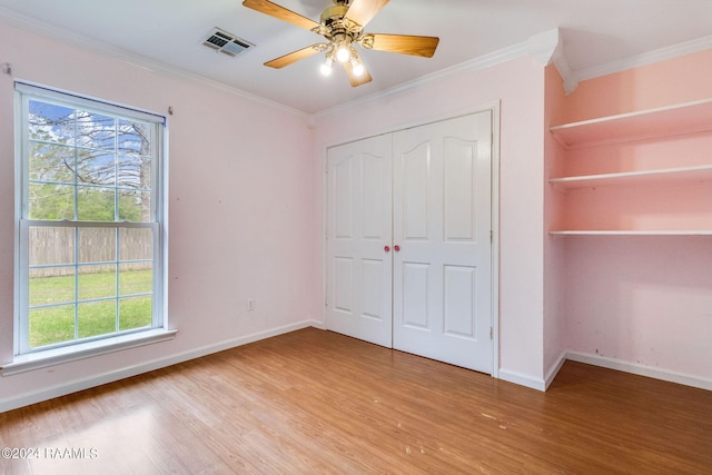 unfurnished bedroom featuring ceiling fan, ornamental molding, and light hardwood / wood-style floors