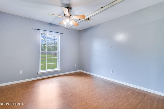 spare room featuring ceiling fan and dark wood-type flooring