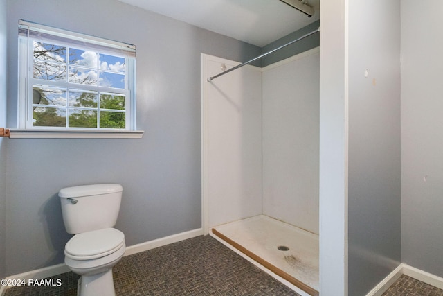 bathroom with toilet and tile floors