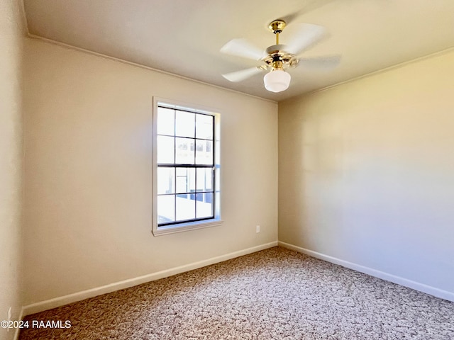 carpeted empty room with ceiling fan and crown molding