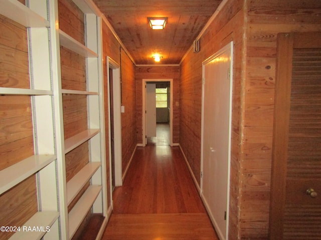 corridor featuring wood walls, hardwood / wood-style flooring, and wooden ceiling