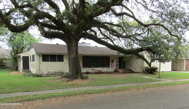 single story home with crawl space, roof with shingles, a chimney, and a front yard