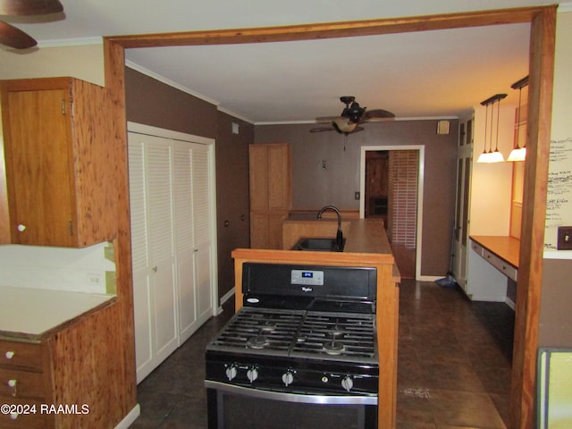 kitchen featuring decorative light fixtures, stove, ceiling fan, dark tile flooring, and sink