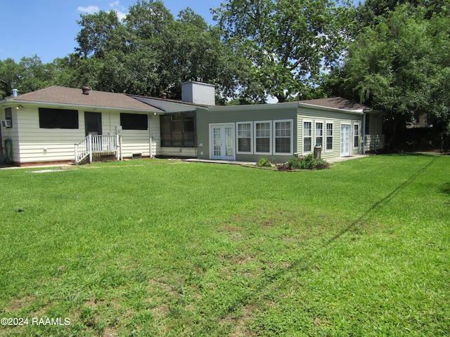 back of house featuring a yard