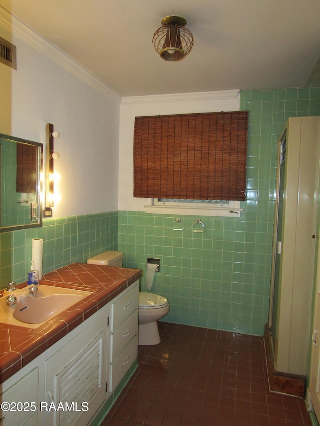 bathroom featuring crown molding, tile walls, visible vents, toilet, and a stall shower