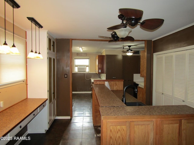 kitchen with crown molding, a ceiling fan, pendant lighting, and a sink