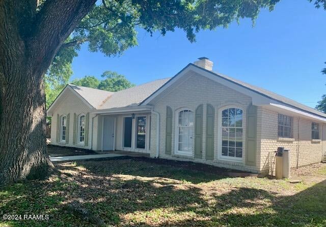 rear view of house with a lawn