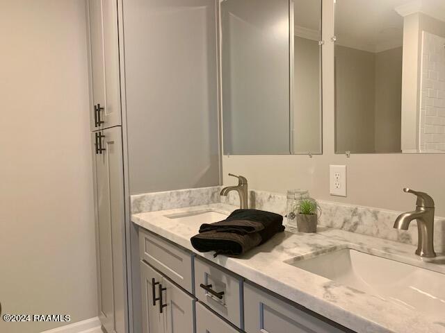 bathroom featuring double vanity and a sink