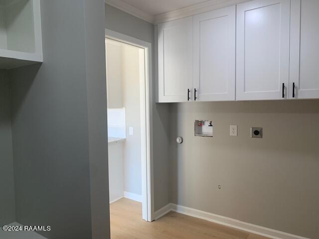 clothes washing area with hookup for a washing machine, hookup for a gas dryer, light wood-type flooring, cabinet space, and electric dryer hookup