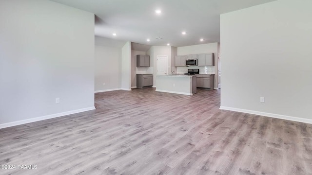 unfurnished living room with wood-type flooring