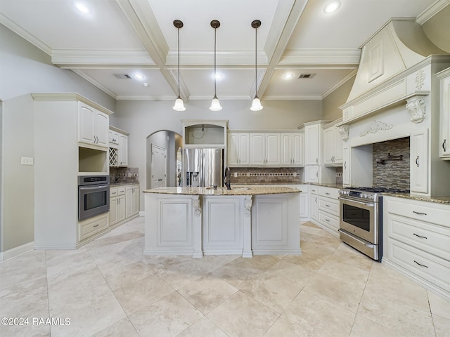 kitchen with white cabinetry, hanging light fixtures, stainless steel appliances, light stone countertops, and an island with sink