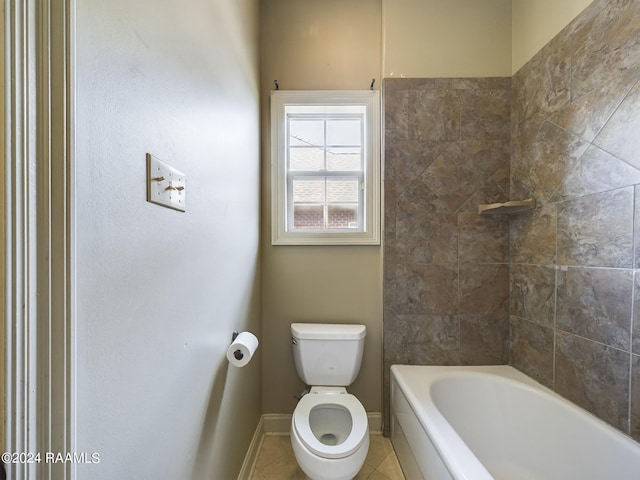 bathroom featuring tiled shower / bath, tile patterned floors, and toilet