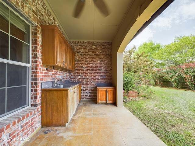 view of patio featuring ceiling fan and sink