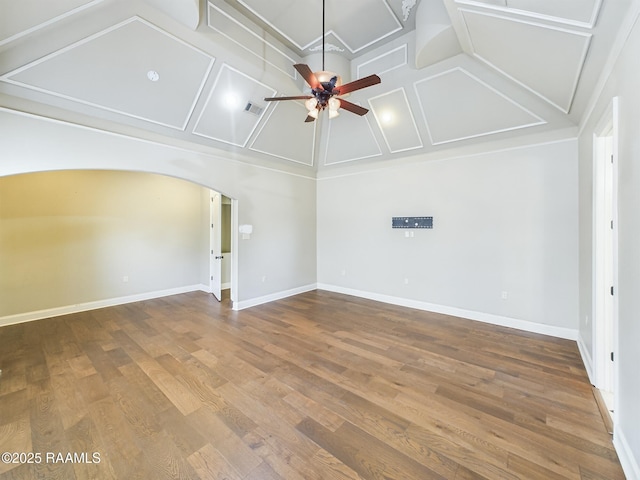 unfurnished room with hardwood / wood-style flooring, ceiling fan, and high vaulted ceiling