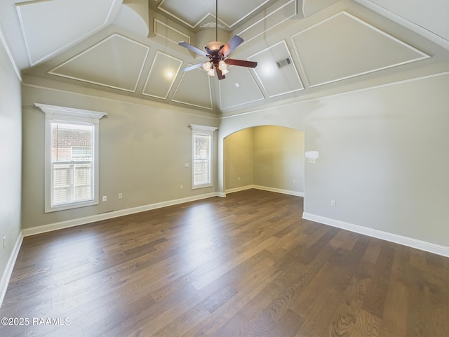 empty room featuring vaulted ceiling, ceiling fan, plenty of natural light, and hardwood / wood-style floors