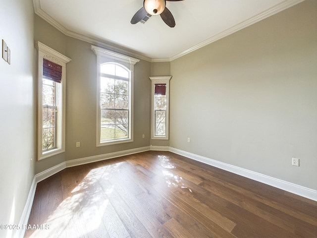 spare room featuring crown molding, dark wood-type flooring, and ceiling fan