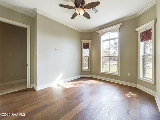 spare room featuring dark wood-type flooring, ceiling fan, and crown molding