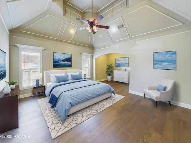 bedroom with ceiling fan, dark hardwood / wood-style floors, and high vaulted ceiling