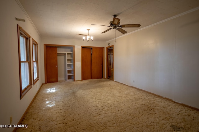 unfurnished bedroom featuring light carpet, crown molding, and ceiling fan with notable chandelier