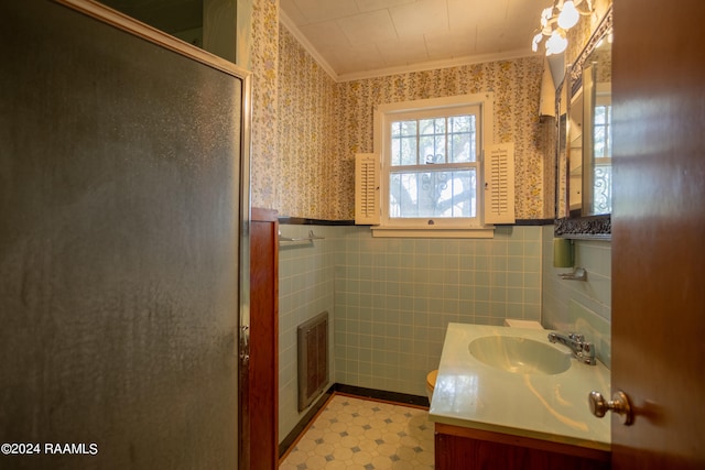 bathroom featuring crown molding, tile walls, tile flooring, and vanity