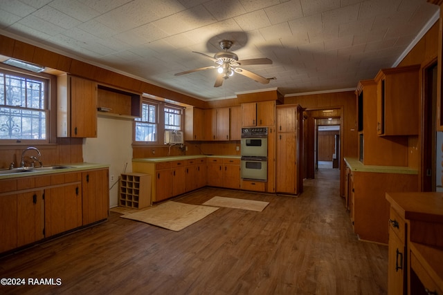 kitchen featuring ceiling fan, sink, dark wood-type flooring, and stainless steel double oven