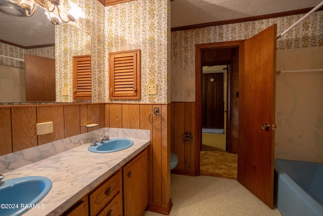 full bathroom with toilet, double sink, shower / bath combination, vanity with extensive cabinet space, and ornamental molding