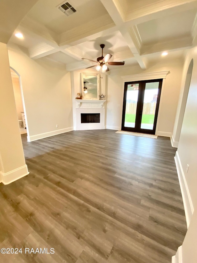 unfurnished living room featuring beam ceiling, french doors, dark hardwood / wood-style floors, coffered ceiling, and ceiling fan