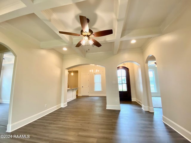 unfurnished room featuring ceiling fan, coffered ceiling, dark wood-type flooring, and beam ceiling