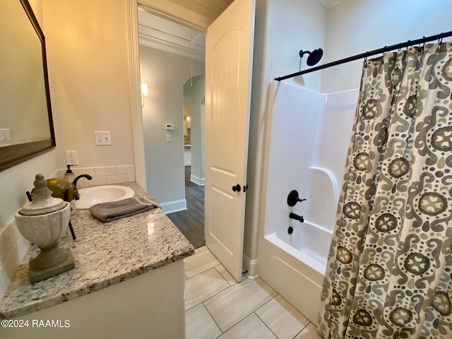 bathroom with tile patterned flooring, crown molding, vanity, and shower / bath combo with shower curtain