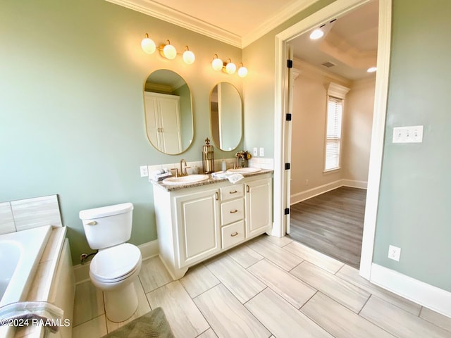 bathroom featuring hardwood / wood-style floors, dual vanity, a bathing tub, crown molding, and toilet