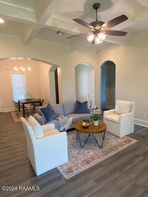 living room with coffered ceiling, beamed ceiling, ceiling fan with notable chandelier, and dark wood-type flooring