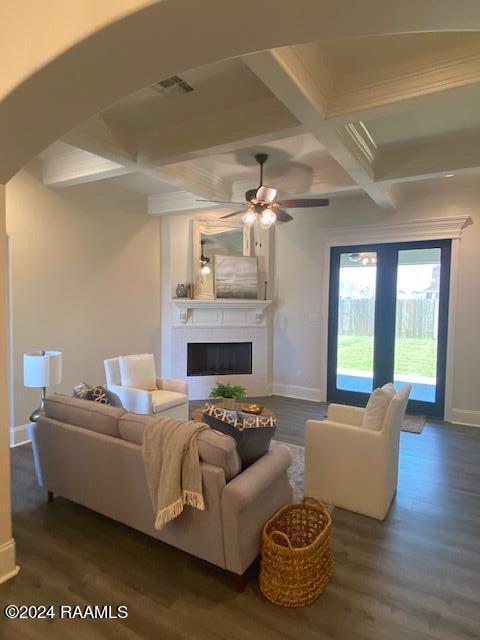 living room featuring ceiling fan, coffered ceiling, dark hardwood / wood-style floors, and beam ceiling