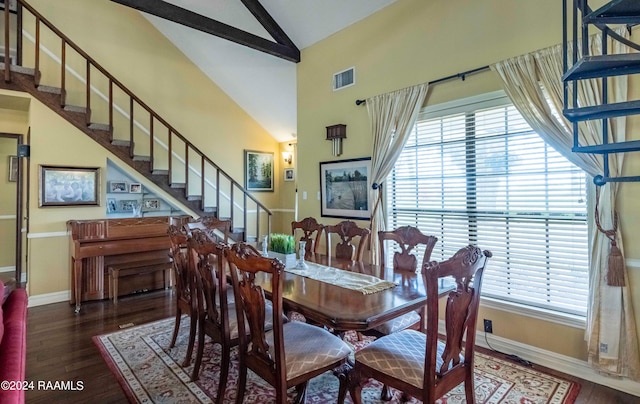 dining area featuring dark wood-type flooring and high vaulted ceiling