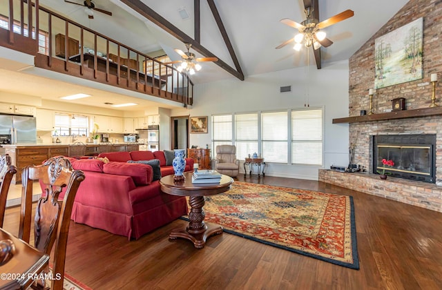 living room featuring high vaulted ceiling, dark hardwood / wood-style flooring, a fireplace, and ceiling fan