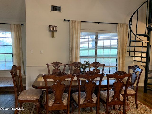 dining space with plenty of natural light and dark hardwood / wood-style floors