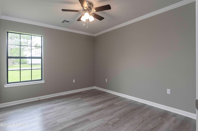 empty room featuring ceiling fan, light hardwood / wood-style flooring, and a wealth of natural light