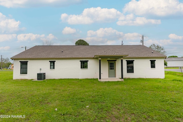 back of house featuring a patio, central AC, and a yard