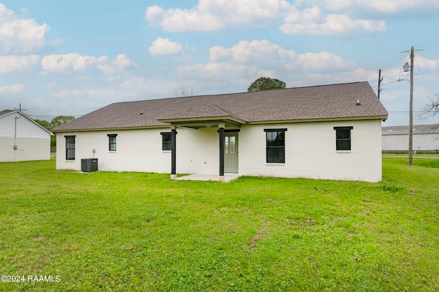 back of property featuring a yard, a patio area, and central air condition unit