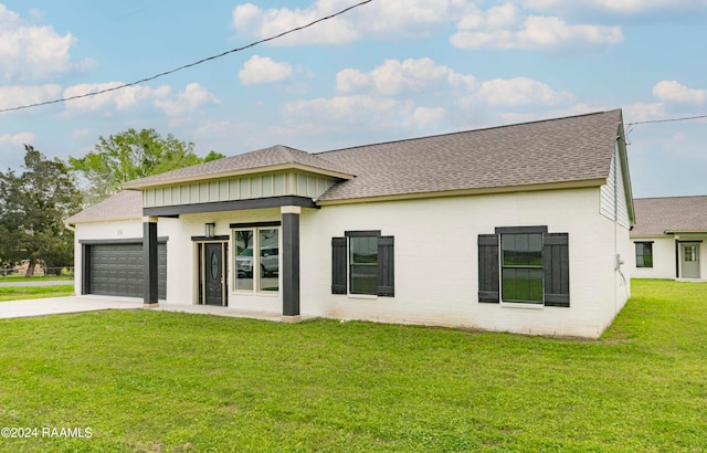 view of front of house with a front lawn and a garage