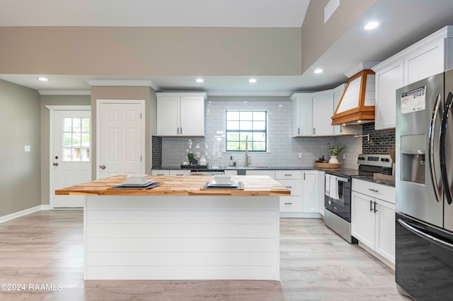 kitchen featuring white cabinetry, appliances with stainless steel finishes, and light wood-type flooring