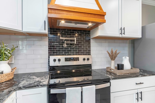 kitchen with white cabinetry, dark stone countertops, tasteful backsplash, and electric range