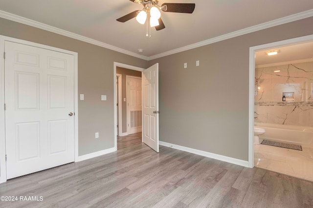 unfurnished bedroom featuring light wood-type flooring, ceiling fan, ensuite bathroom, and ornamental molding