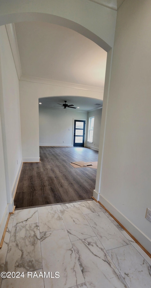 hall featuring ornamental molding and light hardwood / wood-style flooring