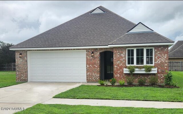 view of front of house with a front yard and a garage