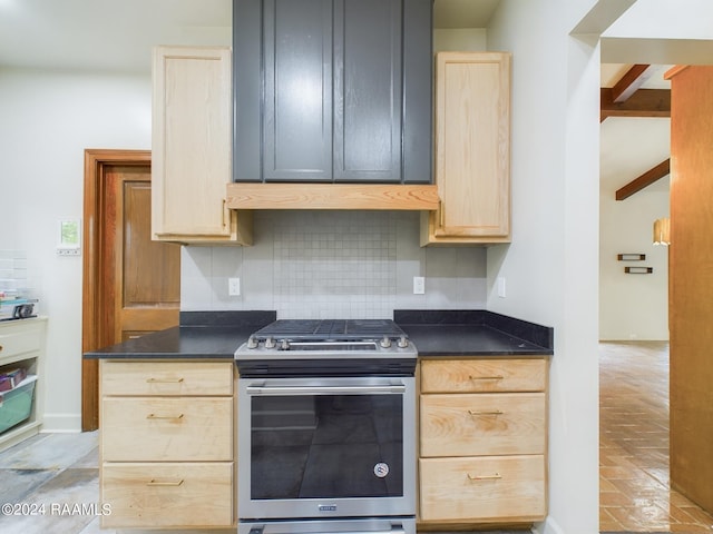 kitchen featuring light brown cabinets, light tile floors, gas range, tasteful backsplash, and premium range hood