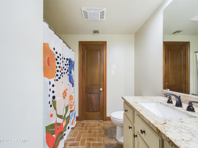 bathroom with oversized vanity and toilet