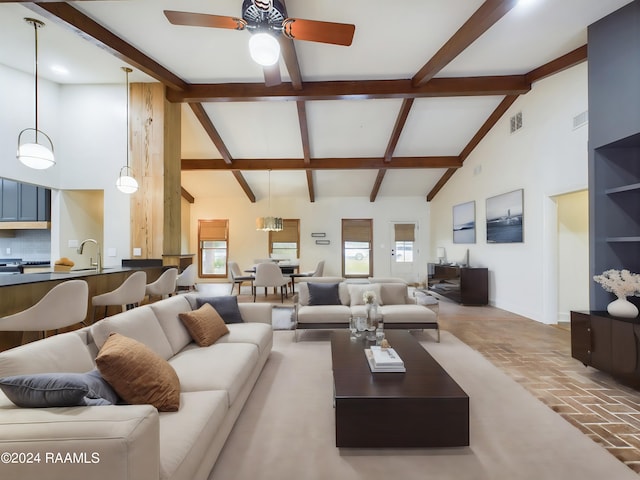 living room with a healthy amount of sunlight, high vaulted ceiling, and ceiling fan