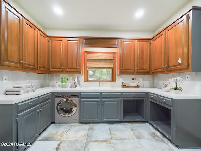 kitchen featuring gray cabinets, washer / dryer, tasteful backsplash, sink, and light tile floors