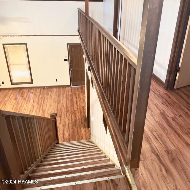 staircase with hardwood / wood-style flooring