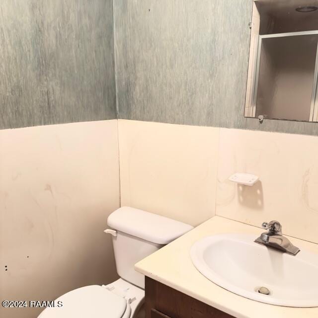 bathroom featuring vanity and toilet